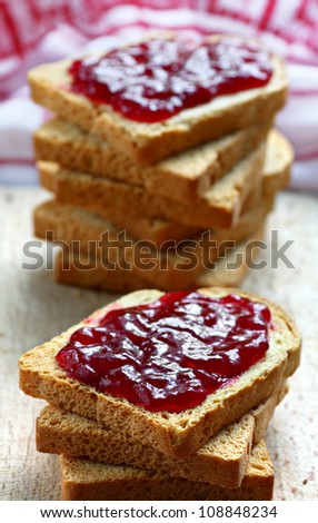 Sandwiches with white bread spread with homemade cherry jam