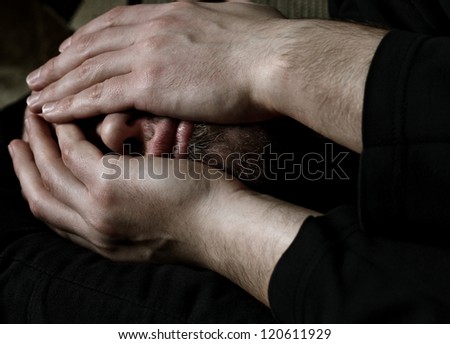 Close up of a Caucasian man covering face with hands from desperation