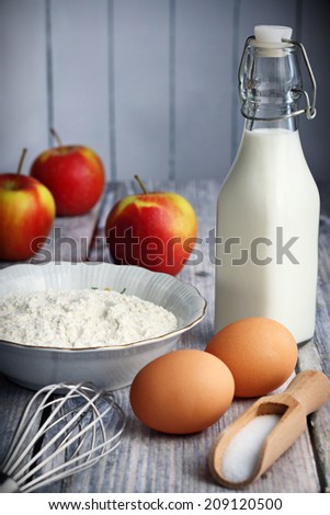 Food ingredients to make American style pancakes with apples including flour, milk, eggs