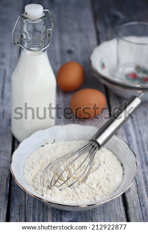Food ingredients to make American style pancakes with apples including flour, milk, eggs