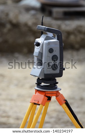 Theodolite on a tripod for surveying on a construction site