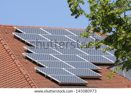 Green energy with solar panels on roof of a house
