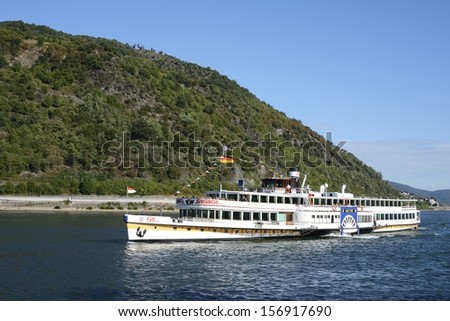 BACHARACH, GERMANY - SEPTEMBER 2: Tourists making a ship round trip on the river Rhine in Bacharach, Germany on September 2, 2013. The ship Goethe of the KD river cruise company is over 100 years old.