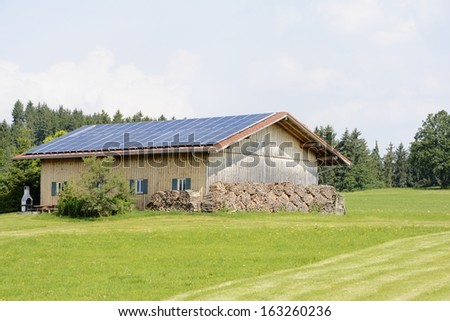 Alternative energy creation at a farm with solar panels on the roor