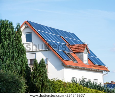 Modern house with photovoltaic solar cells on the roof for alternative energy production