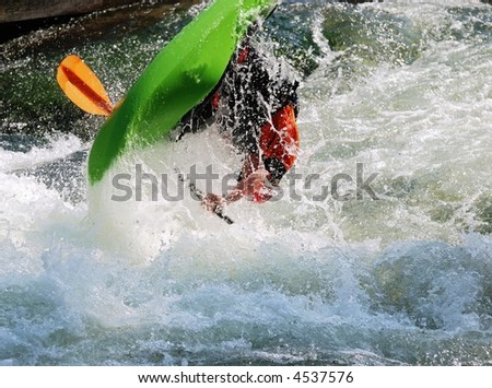 Kayak turning over with a big jump in the air.