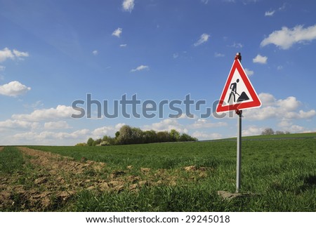 Construction site traffic sign in natural landscape