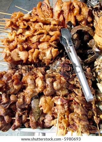 A Huge Pile of Meat Kebabs at a Food Stand