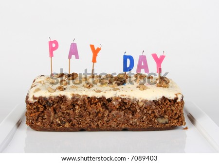 A cake celebrating \'pay day\' with the candles blown out
