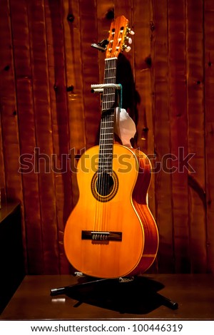 Classic spanish guitar  near of a wood wall