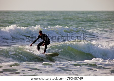 SAN FERNANDO, CADIZ, SPAIN - FEB 19: Unknown surfer takes waves on the 2nd championship of Surf and BodyBoard Impoxibol on Feb 19,2011 on the beach of Camposoto of San Fernando, Cadiz, Spain