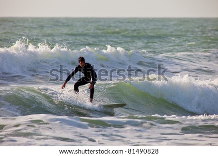 SAN FERNANDO, CADIZ, SPAIN - FEB 19: Unknown surfer taking waves on the 2nd championship of Surf and BodyBoard Impoxibol on Feb 19,2011 on the beach of Camposoto of San Fernando, Cadiz, Spain