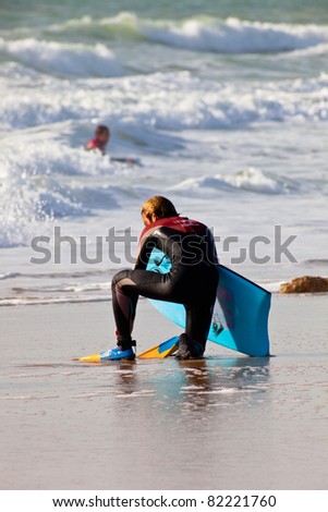 SAN FERNANDO, CADIZ, SPAIN - FEB 19: Unknown bodyboader leaving the water on the 2nd championship of Surf and BodyBoard Impoxibol on Feb 19,2011 on the beach of San Fernando, Cadiz, Spain