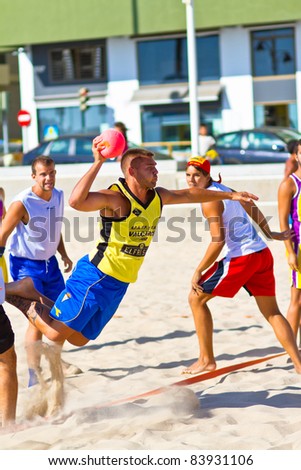 CADIZ, SPAIN - JULY 19: Unidentified player of Los Negritos throwing the ball in a match versus Ademar Adentro in the 19th league of beach handball of Cadiz on July 19, 2011 in Cadiz, Spain