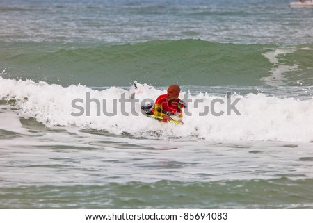 SAN FERNANDO, CADIZ, SPAIN - FEB 19: Unknown bodyboader taking waves on the 2nd championship of Surf and BodyBoard Impoxibol on Feb 19, 2011 on the beach of Camposoto of San Fernando, Cadiz, Spain