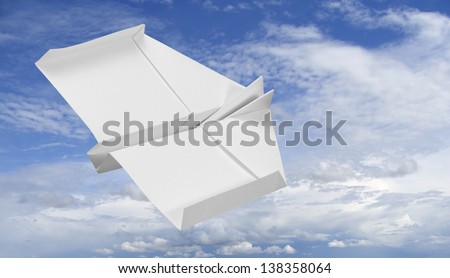 white paper plane flying in the sky