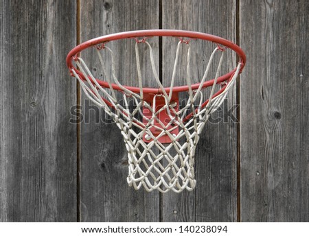 a basketball basket on weathered wooden facade