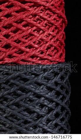 detail of two stacked red and black string coils