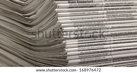 full frame background with lots of stacked newspapers