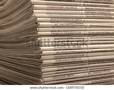 full frame background with lots of stacked newspapers