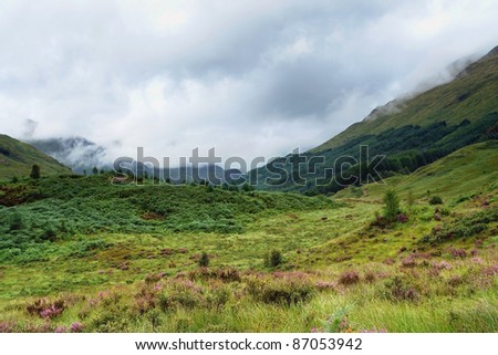hilly scenery in Scotland around Glenfinnan at summer time with deep hanging clouds at summer time