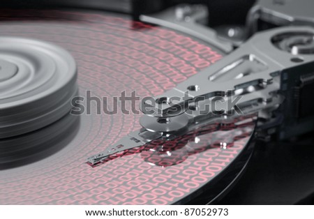 studio photography showing the detail of a opened hard drive and symbolic data processing
