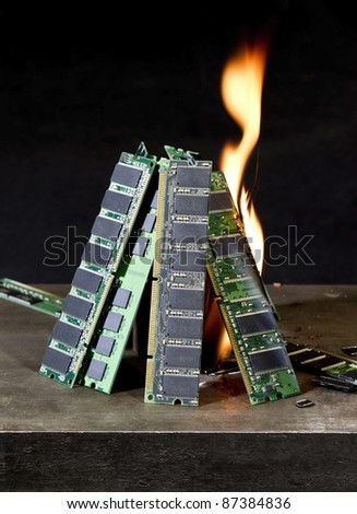 pile of random access memory sticks and flame in front of dark back