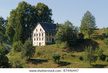 idyllic scenery with single house in the Black Forest at summer time