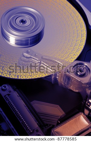 studio photography of a opened hard disk at work with symbolic data while processing