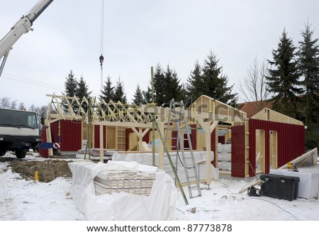 construction of a wooden house at winter time