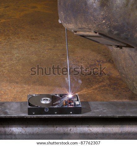welding scenery with hard disk drive, welding mask detail and flying sparks
