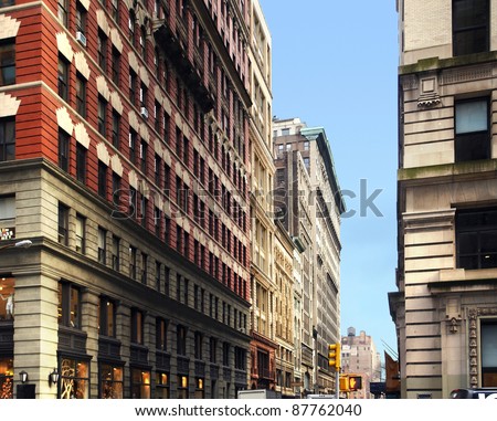 street scenery with house facades in New York (USA) in front of blue sky