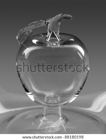 transparent bright apple sculpture formed with glass in grey back