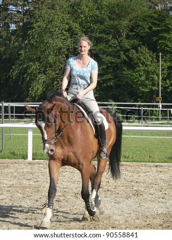 frontal shot of a horse riding woman on a parcours in sunny ambiance