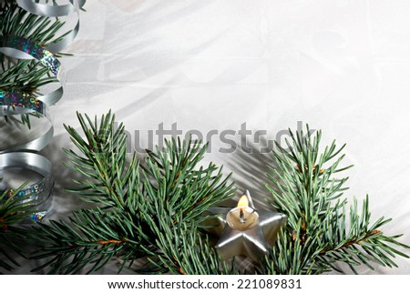 silver Christmas background with candle and needles