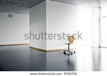 a single wooden chair in a bright empty room with a wall clock and sunlight and sunbeams shining from outside