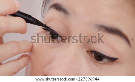 Cosmetics & make-up. Beautiful female eye with black eye liner makeup on face