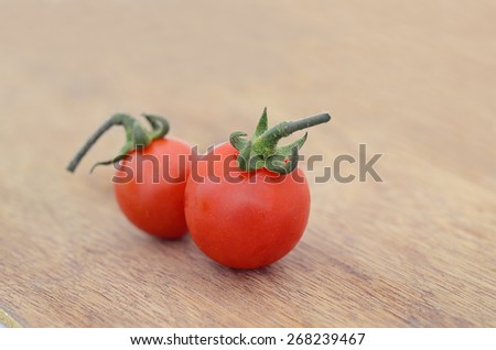 Fresh Tomato on wood texture background