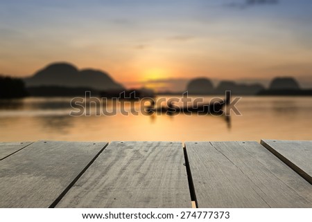 Defocused and blur image of terrace wood and beautiful seascape and fisherman in morning view for background usage