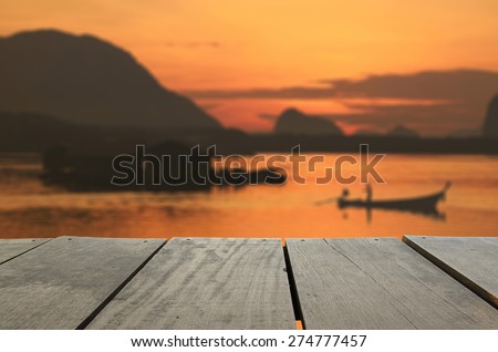 Defocused and blur image of terrace wood and beautiful seascape and fisherman in morning view for background usage