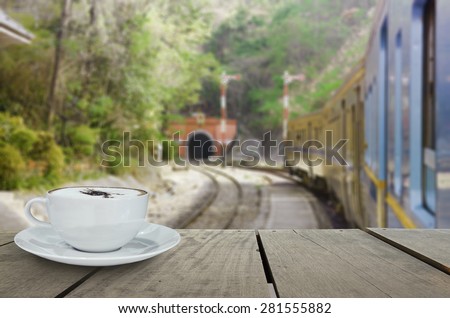 Defocus with terrace wood and cappuccino coffee with train into tunnel for background usage