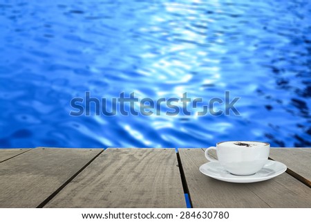 veranda wood and coffee inside river (Blur background)