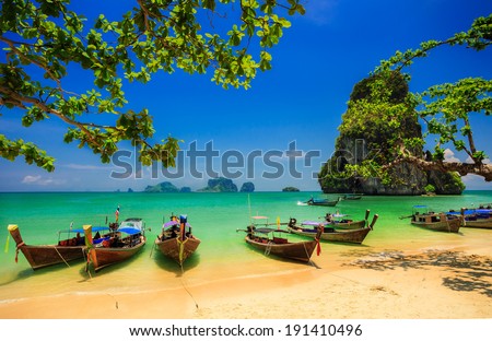 Traditional longtail boat at sunset on tropical island, Thailand