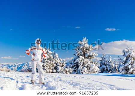 Serious skier in white clothes on the top of mountain. Sarikamis. Turkey