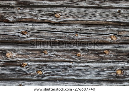 fragment of the old country house of natural wooden timbers without coloring with a number of snags