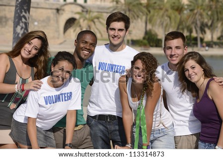 happy and diverse volunteer group smiling outdoors