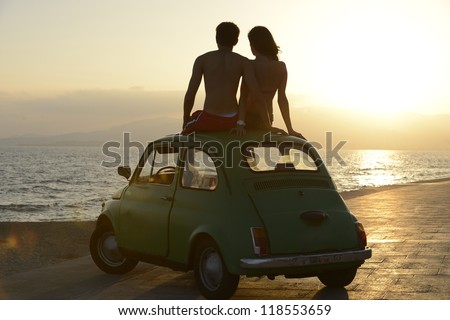 Romantic Vacation: Couple At Sundown On The Beach With Car