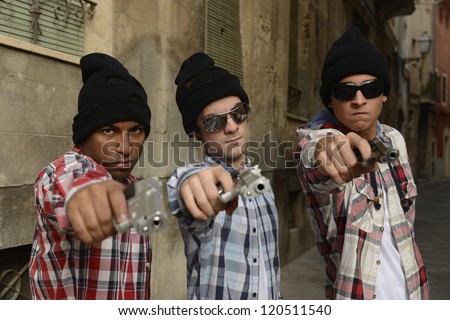 Portrait of gang members with guns on the street