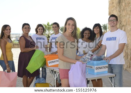 Charity: Happy Group Of Volunteers Collecting Clothing Donations