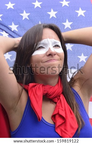 American woman Latin descent, disappointed with flag of United States of America in the background ground